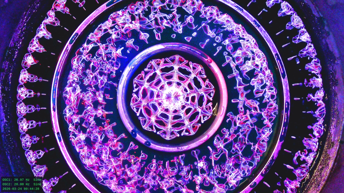 Cymatics water pattern at 26.97 Hz — composite burst showing Faraday wave nodal structure